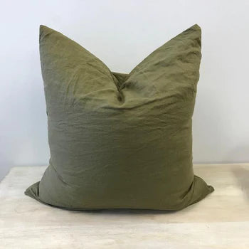 An olive coloured French flax linen cushion cover with feather inner, chopped top styling.