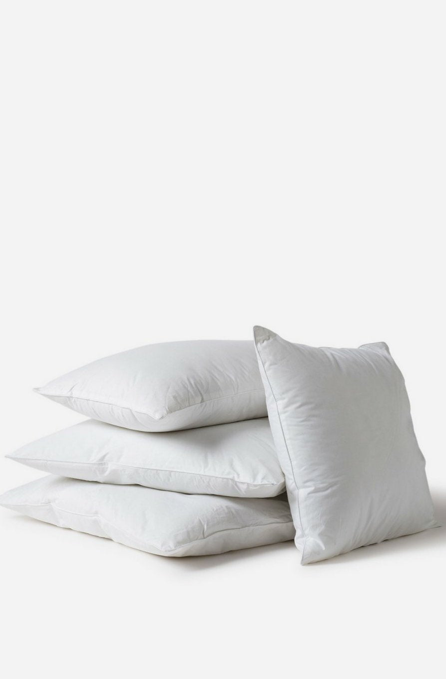 3 Città Design Microfibre Cushion Inners Stacked with a 4th inner leaning against the stack on a white background