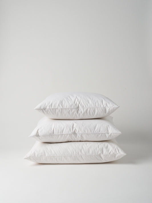 Stack of white feather and down cushion inners, NZ homeware