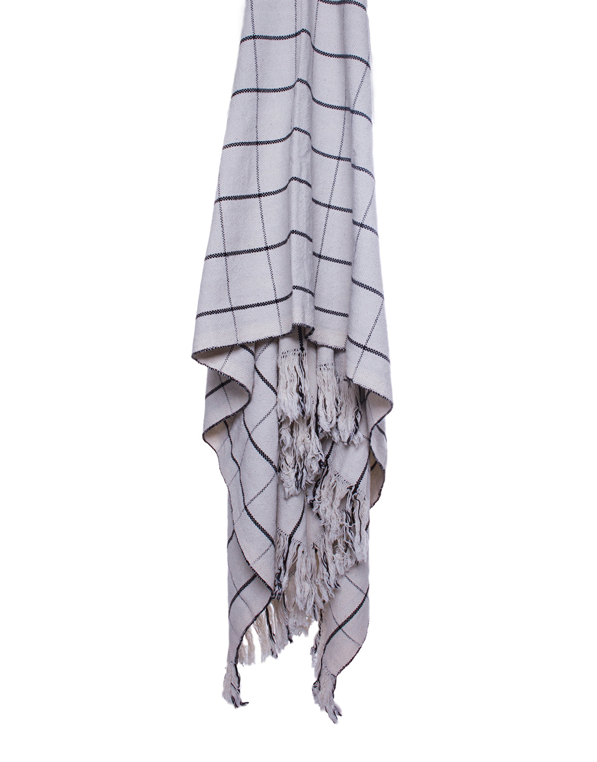 Cotton white and black checkered blanket draped across a flat white surface